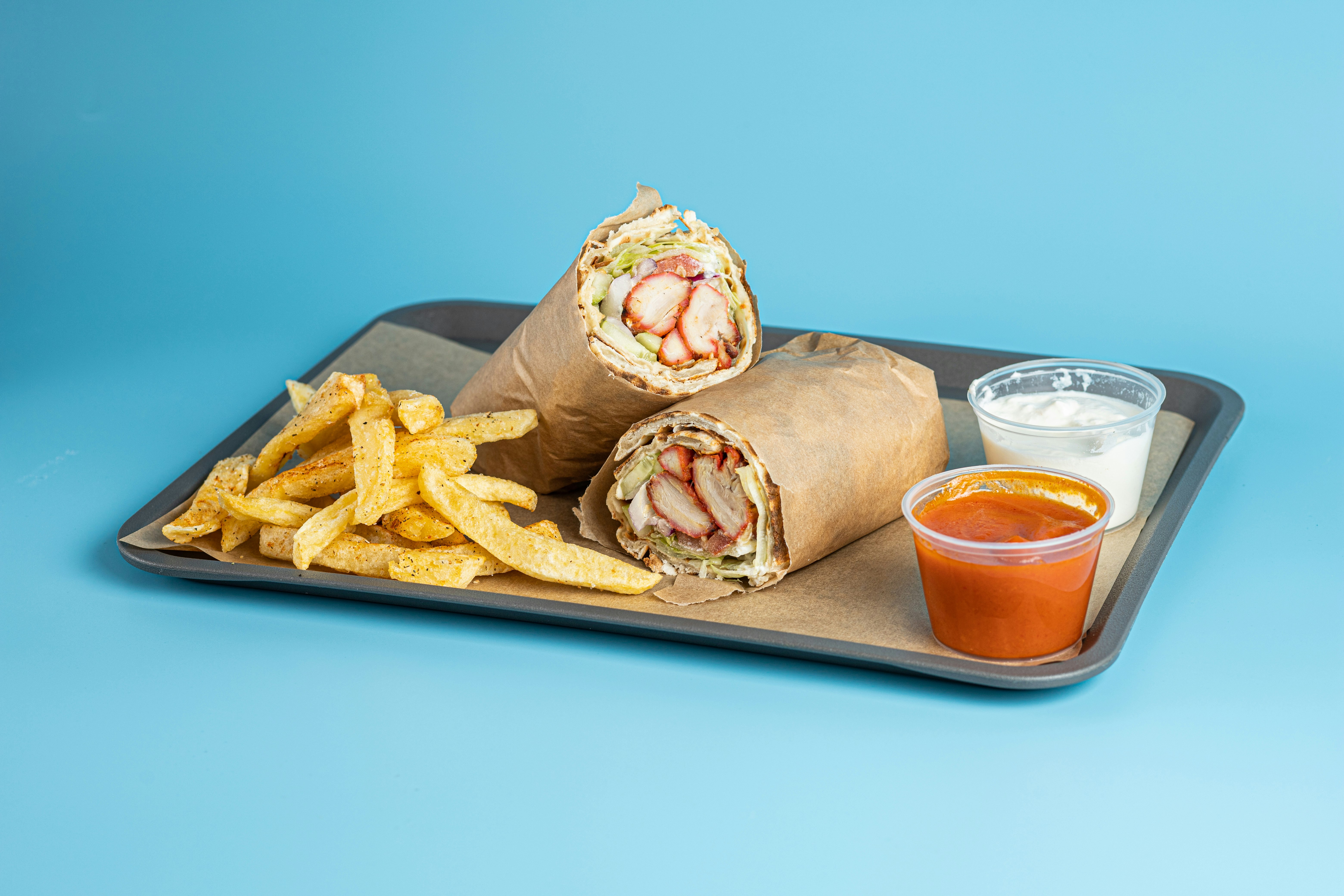 burger and fries on brown wooden tray